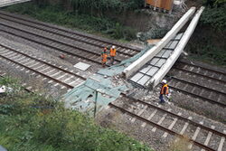 Zwei halbe eingestürzte Brückenträger auf dem Bahngleis