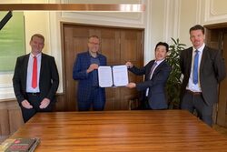 Von links: Christian Baierl, Oberbürgermeister Uwe Schneidewind, Tao Jiang und Hanno Rademacher präsentieren das unterschriebene Abkommen zur zukünftigen Kooperation mit China bei Klimaschutz-Themen.
