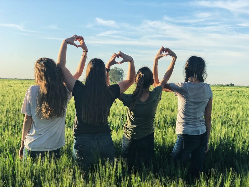 4 Mädchen bilden mit den Händen Herzen