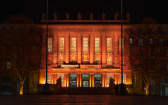 Das orange illuminierte Rathaus