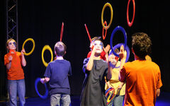 Kinder die mit Ringen jonglieren