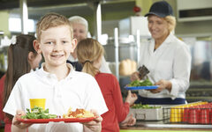 Male Pupil With Healthy Lunch In School Cafeteria