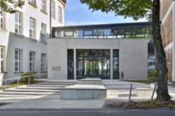 Der neue Eingang zum Gymnasium Bayreuther Straße mit Eingangsportal und einem Gang aus Glas