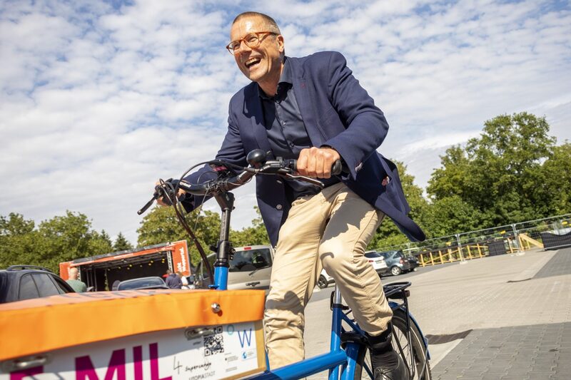 Oberbürgermeister Uwe Schneidewind auf einem Lastenrad fahrend