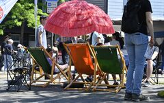 Liegestühle und eine Sonnenschirm auf einer Straße