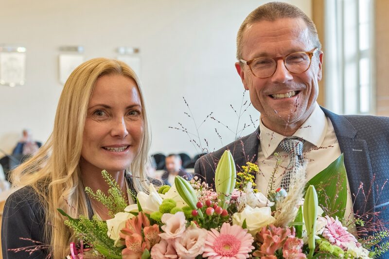 Oberbürgermeister Uwe Schneidewind gratuliert Sandra Zeh im Ratssaal, im Vordergrund ein Blumenstrauß